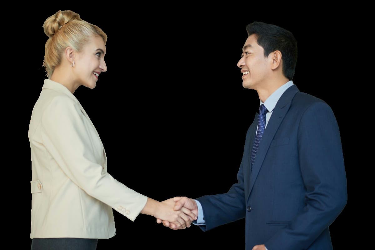 A businesswoman and businessman smiling and shaking hands